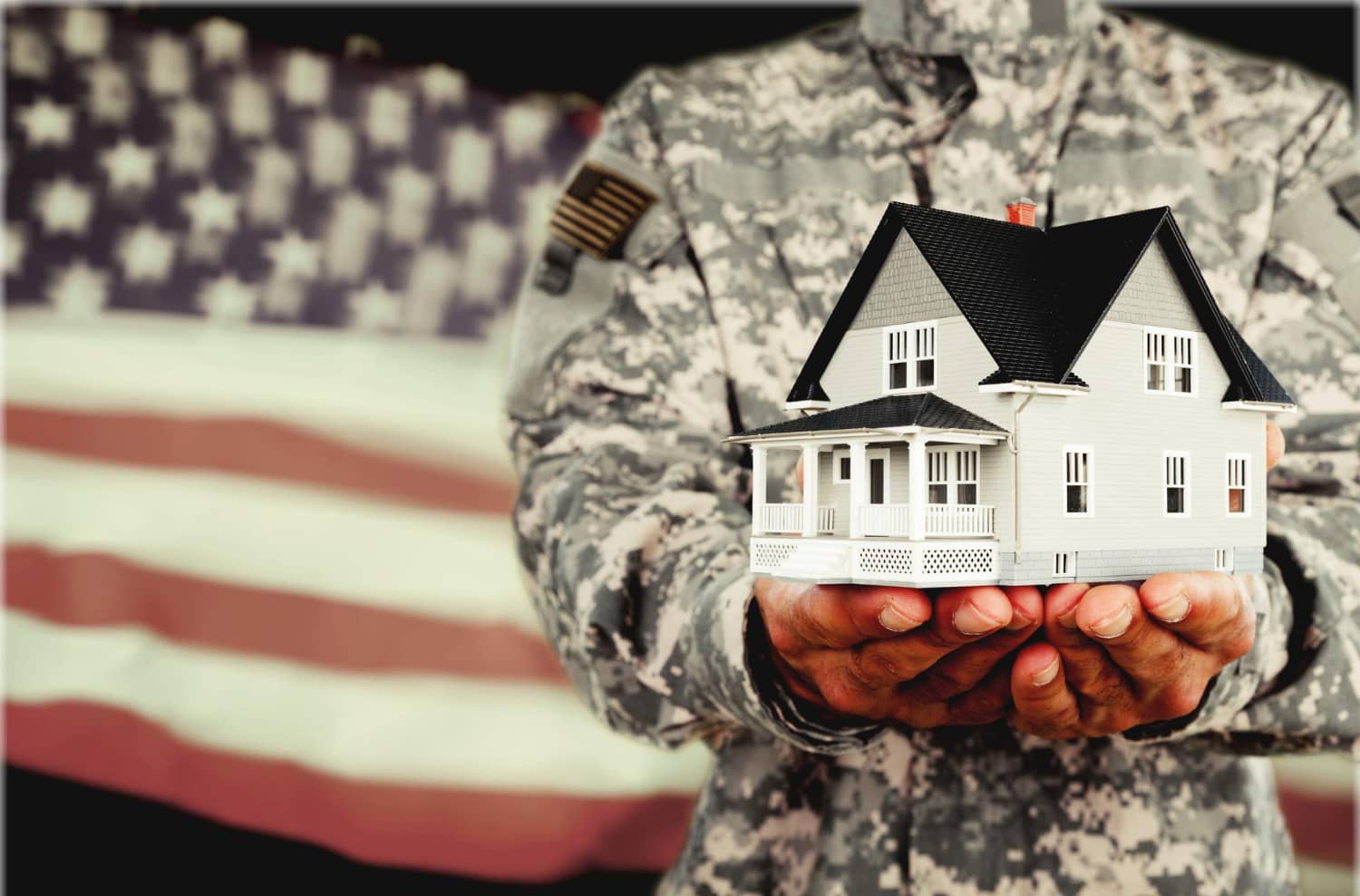 veteran family standing in front of their new home